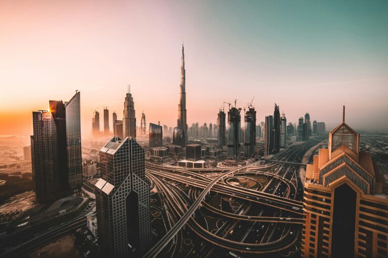 Burj Khalifa tickets 2026 — the tower rising above the Dubai skyline at sunset, with surrounding skyscrapers and a dramatic sky