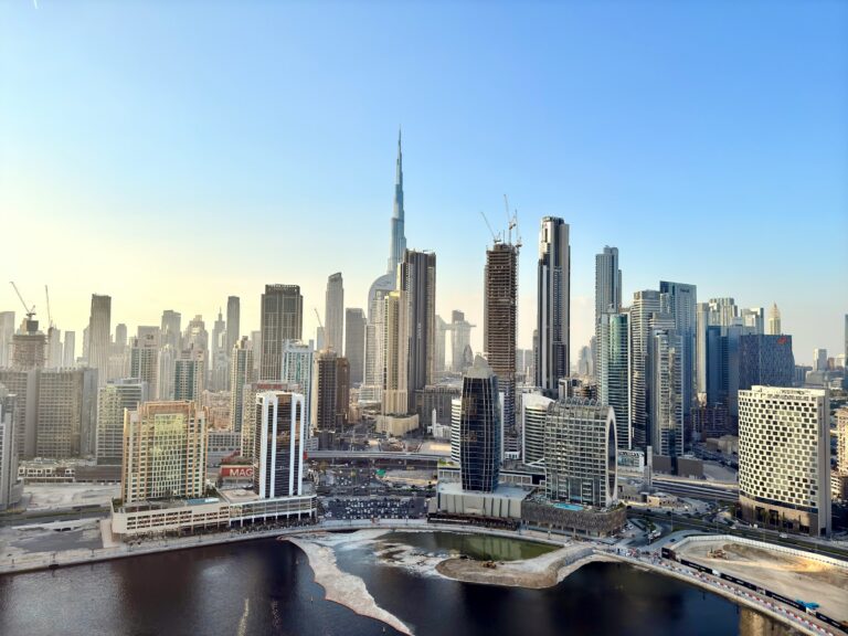 Burj Khalifa and the Dubai downtown skyline at golden hour with dramatic clouds over the city