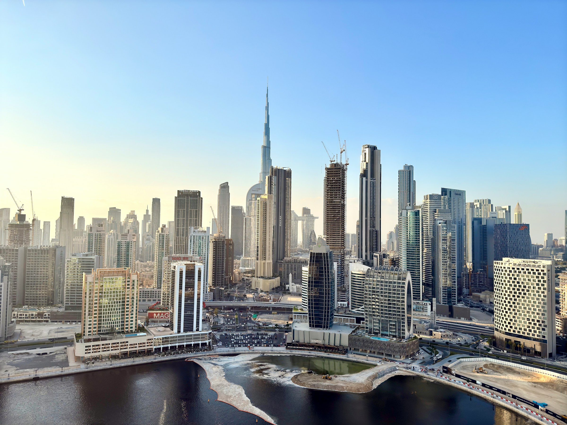 Burj Khalifa and the Dubai downtown skyline at golden hour with dramatic clouds over the city