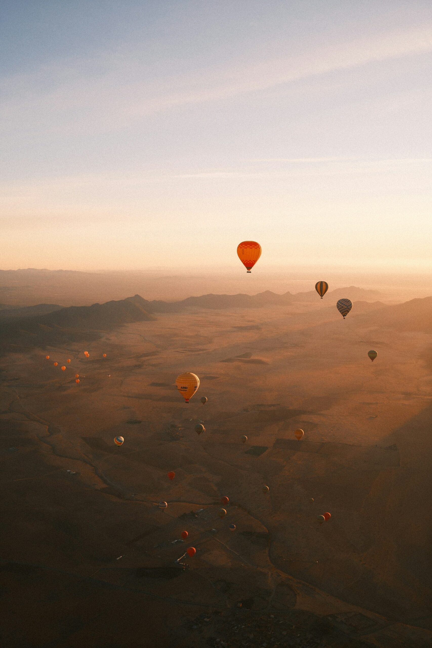 Hot air balloon Dubai flight floating above desert dunes at sunrise