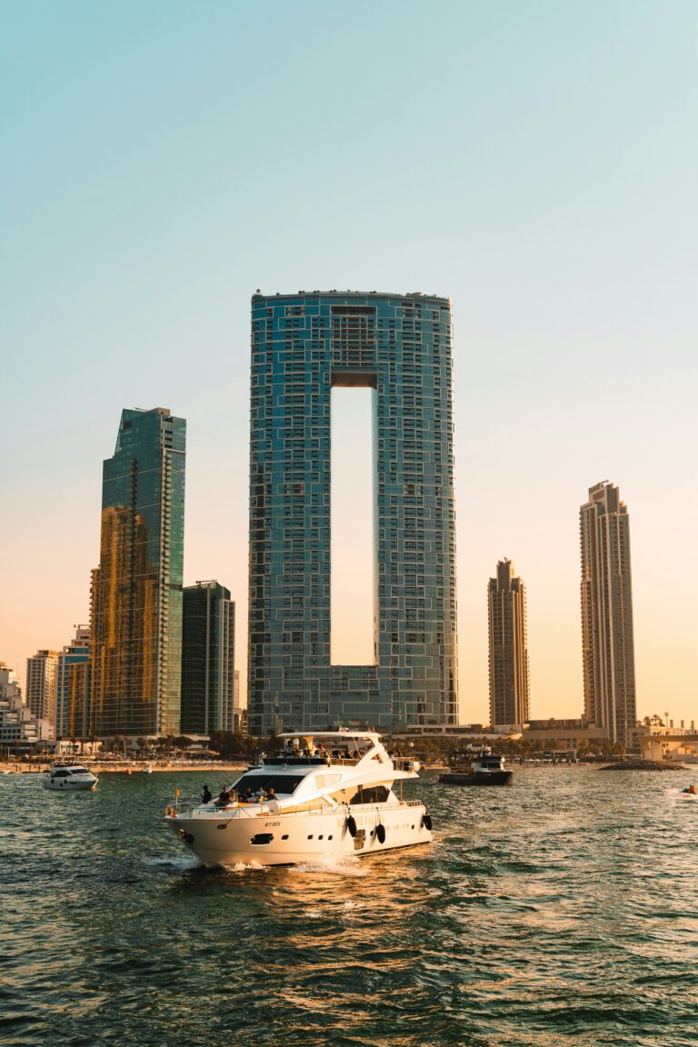 Dubai yacht rental cruising past Dubai Marina skyscrapers at sunset