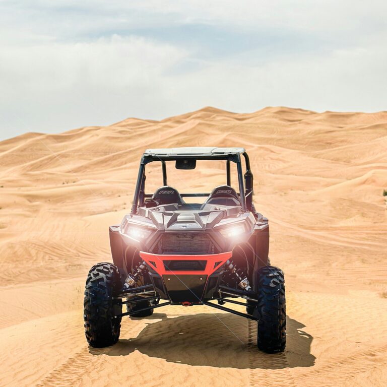 Dubai dune buggy parked against rolling golden desert dunes